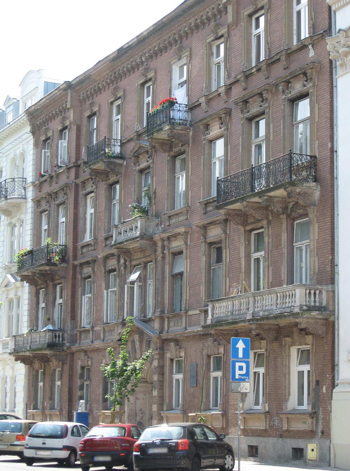 Interesting architectural details in the brick and stone facade of a Warsaw building.