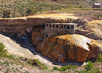 Puente del Inca, or "The Inca Bridge" is a natural bridge that spans across the Cuevas River in the Province of Mendoza, Argentina. Mineral deposits from hot springs have led to colorful shades of red and yellow on the face of the rocks. Though the area has been known since pre-Columbian times, it was famously visited and described by Charles Darwin in 1835. 
