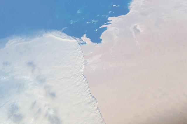 A massive sandstorm over the Persian Gulf state of Qatar blows southward (to the right) toward southeastern Saudi Arabia and the United Arab Emirates in this image photographed from the International Space Station. Image courtesy of NASA. 