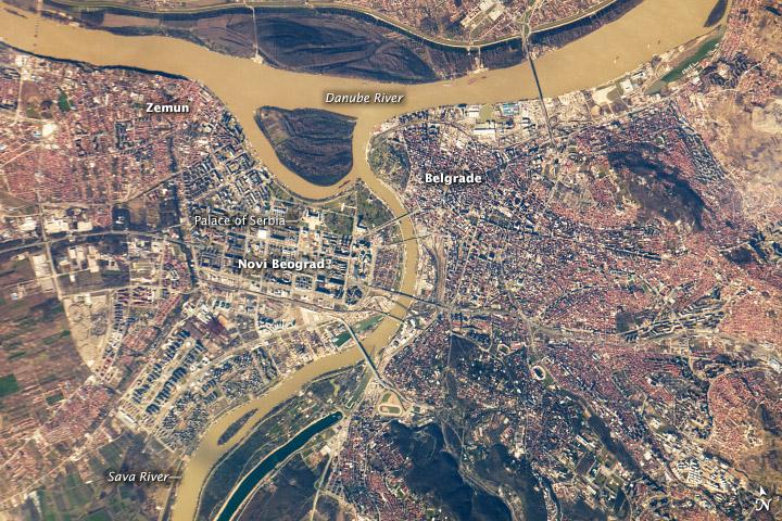 Belgrade, located at the confluence of the Danube and Sava Rivers,  is the capital of the Republic of Serbia. The core of old Belgrade - known as Kalemegdan - is located along the right banks of both the Danube and the Sava Rivers (image center). To the west across the Sava, Novi Beograd (New Belgrade) was constructed following World War II. The difference in urban patterns between the older parts of Belgrade and Novi Beograd is striking in this astronaut photograph from the International Space Station. Novi Beograd has an open grid structure formed by large developments and buildings such as the Palace of Serbia - a large federal building constructed during the Yugoslav period, now used to house elements of the Serbian Government. By contrast, the older urban fabric of Belgrade is characterized by a denser street grid and numerous smaller structures.

Other suburban and residential development (characterized by red rooftops) extends to the south, east, and across the Danube to the north. The location of Belgrade along trade and travel routes between the East and West contributed to both its historical success as a center of trade and its fate as a battleground. Today, the city is the financial center of Serbia, while Novi Beograd supports one of the largest business districts in southeastern Europe. Image courtesy of NASA.
