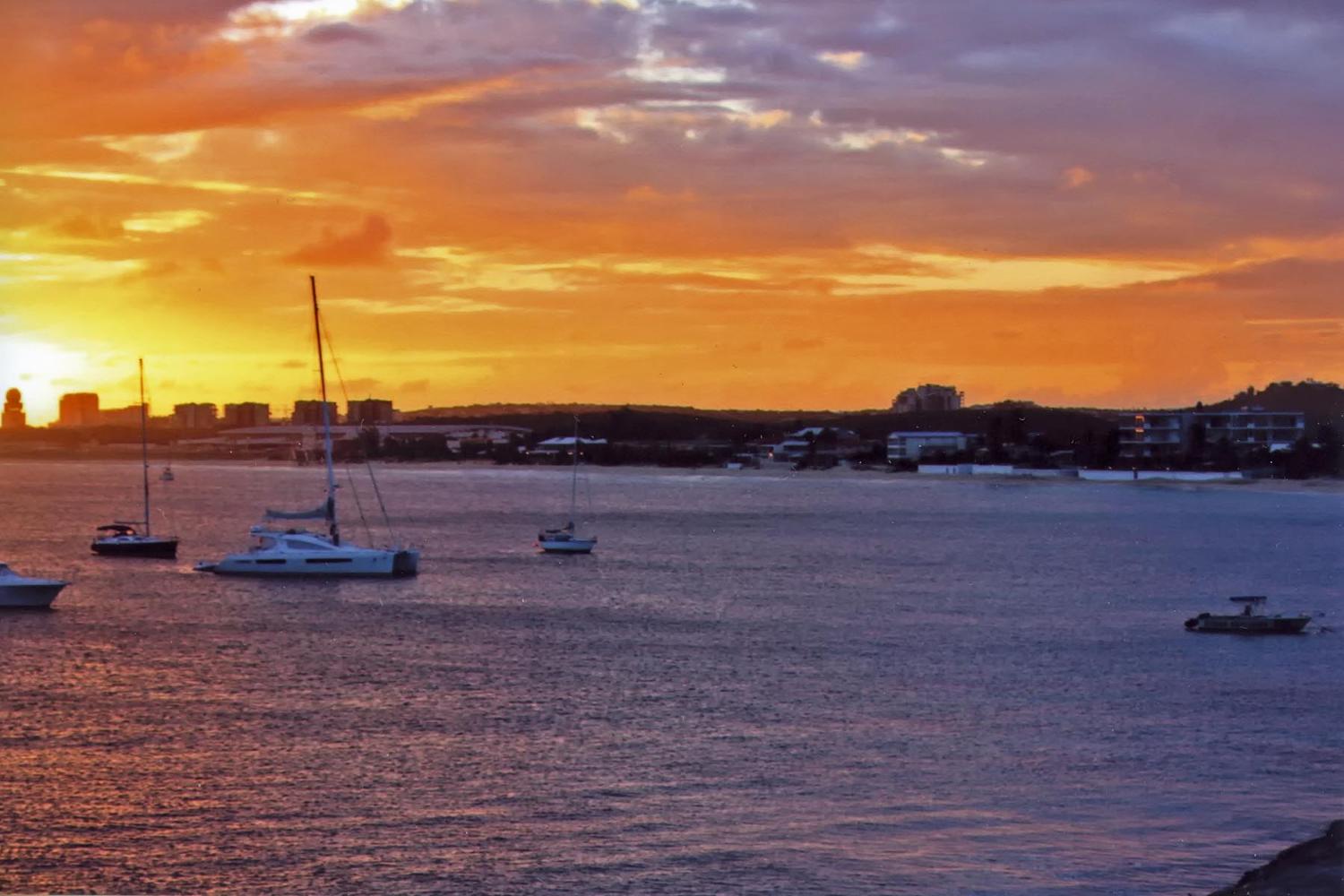 Princess Juliana International Airport at sunset as seen from across Simpson Bay Lagoon. The airport serves both the Dutch and French halves of the island. 