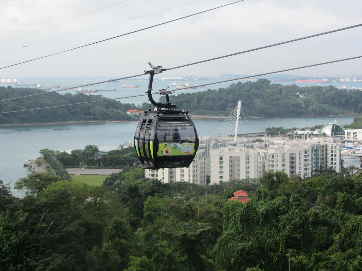 View from Mount Faber of cable car connecting mainland Singapore to Sentosa Island. The coast of Indonesia may be seen in the distance.