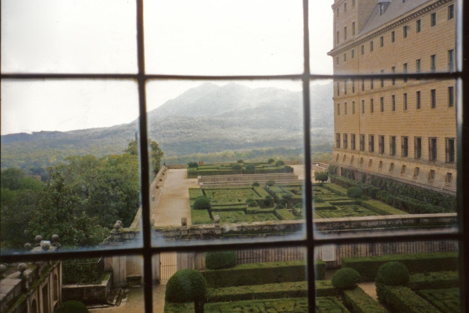 View of the gardens through a window at the El Escorial.