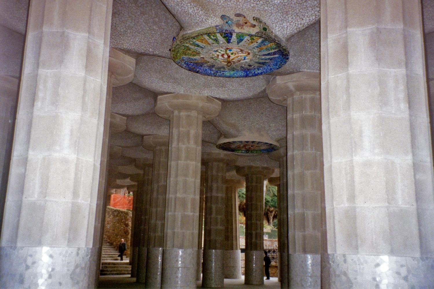 Doric columns supporting the roof of the lower court that forms the central terrace at the unique Park Guell garden complex in Barcelona. Designed by the Catalan architect Antoni Gaudi and built between 1910 and 1914, the park is full of his mosaics including this ceiling rondel. 