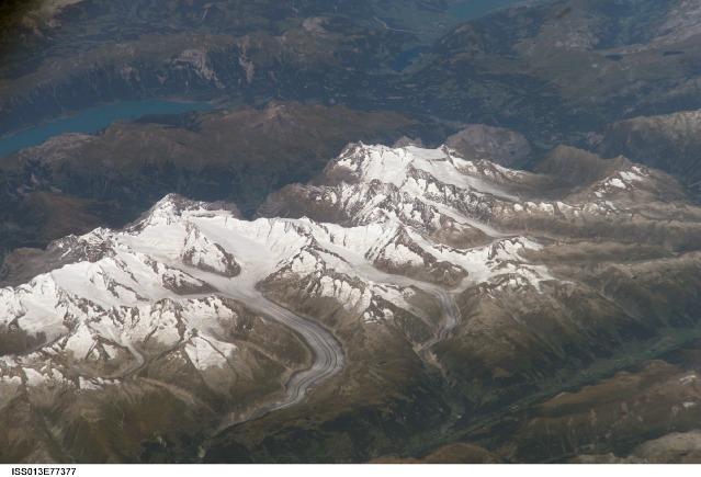 Three of the higher peaks of the Bernese Alps are visible -Jungfrau (4,158 m), Moench (4,089 m), and Eiger (3,970 m). To the east and south of the Jungfrau is the Aletsch Glacier, clearly marked by dark medial moraines extending along the glacier's length parallel to the valley axis. Moraines are formed from rock and soil debris scoured along the sides of mountain glaciers that gradually accumulate in the middle of the glacier and are carried along the flow direction. Lake Brienz to the northwest is glacially carved. Image courtesy of NASA.