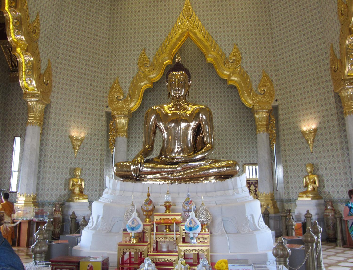 The Suhhthai Traimit Golden Buddha image is the largest Golden Buddha image in the world. Made of pure gold, it is 3 m (9.8 ft) tall and weighs 5.5 tons. The Buddha was probably constructed in the 13th or 14th centuries. At some point it was covered in plaster and painted to prevent its theft. Its origins were forgotten and it was brought to Bangkok from a ruined temple in Ayutthaya in the early 19th century. In 1955, the Buddha was dropped while being moved and part of its plaster covering broke revealing the gold underneath. In 2010, a new building was erected at the Wat Traimit Temple to house the Golden Buddha, which is valued at close to $300 million dollars. 