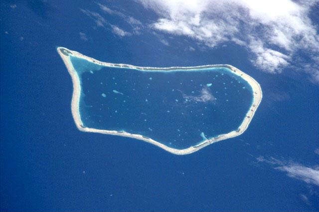 Nukunonu is the largest of the three islands that comprise Tokelau. It is composed of a roughly tear-drop shaped atoll that includes 5.5 sq km of land and whose central lagoon encompasses an area of about 90 sq km. Image courtesy of NASA. 