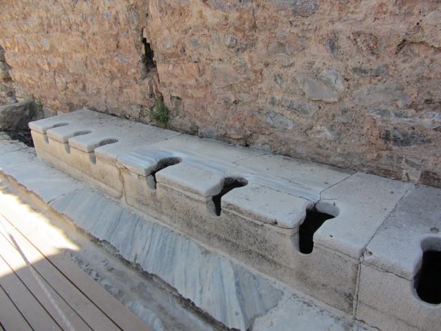 The public toilets in Ephesus were located in the public baths and had running water. Servants were often employed as seat warmers before the patrons used the cold stone seats. An inscription on a wall reads: "Close your eyes, count slowly to 10, and it will come."
