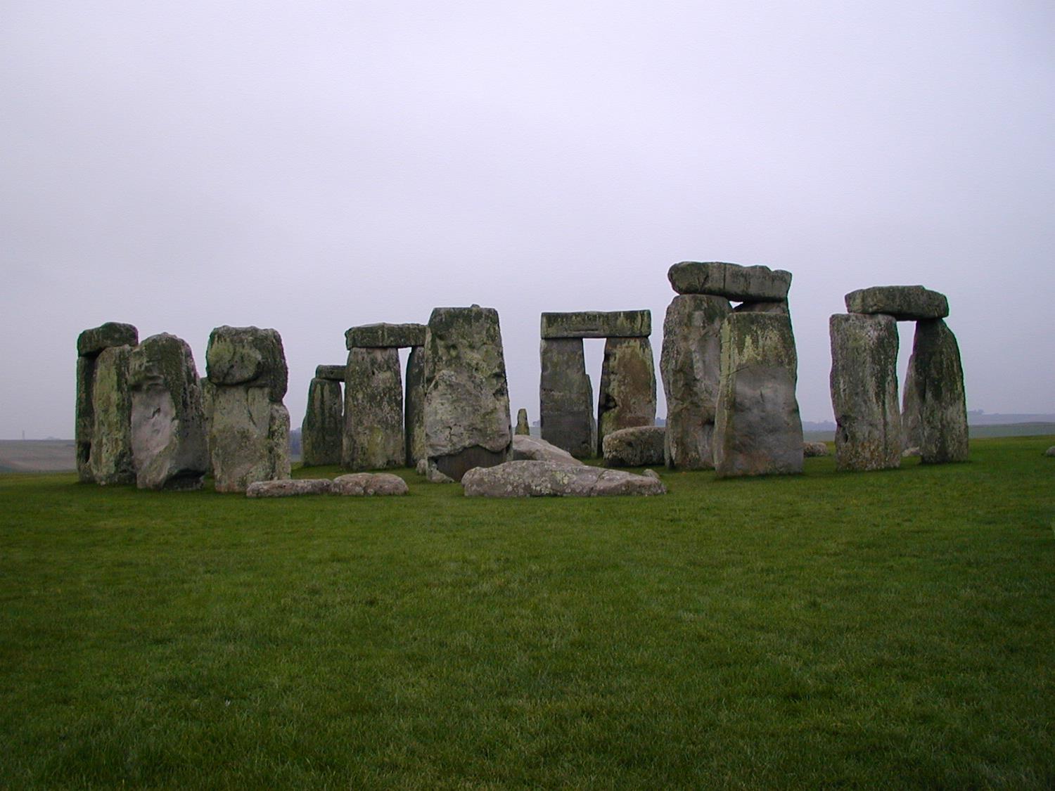 Stonehenge as seen from the north barrow, Wiltshire County, England. The stone circle was built about 2500 B.C. by a non-writing culture and is composed of earthworks surrounding a circular setting of large standing stones with several hundred burial mounds. Among its many suggested functions are that it may have served as: an astronomical observatory, a religious site, a domain of the dead, or a place of healing. The site has also been connected to Arthurian legend.