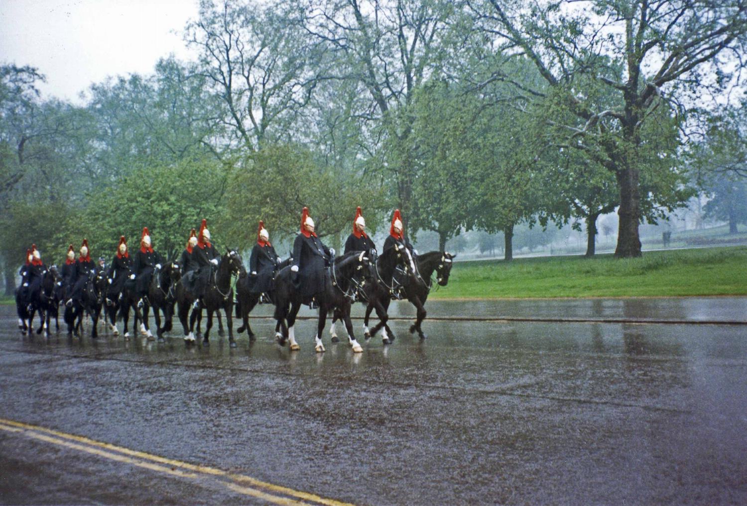 An element from The Blues and Royals, in their distinctive blue rain capes, passing along a damp London street. The Blues and Royals are part of the Household Cavalry Regiment performing ceremonial duties on state and royal occasions as well as an armored reconnaissance unit taking part in active military operations around the world. As one of the senior regiments of the British Army, the lineage of The Blues and Royals includes The Royal Horse Guards (Blues) and The Royal Dragoons (1st Dragoons) dating back to the Restoration Period of 1660-1661. 