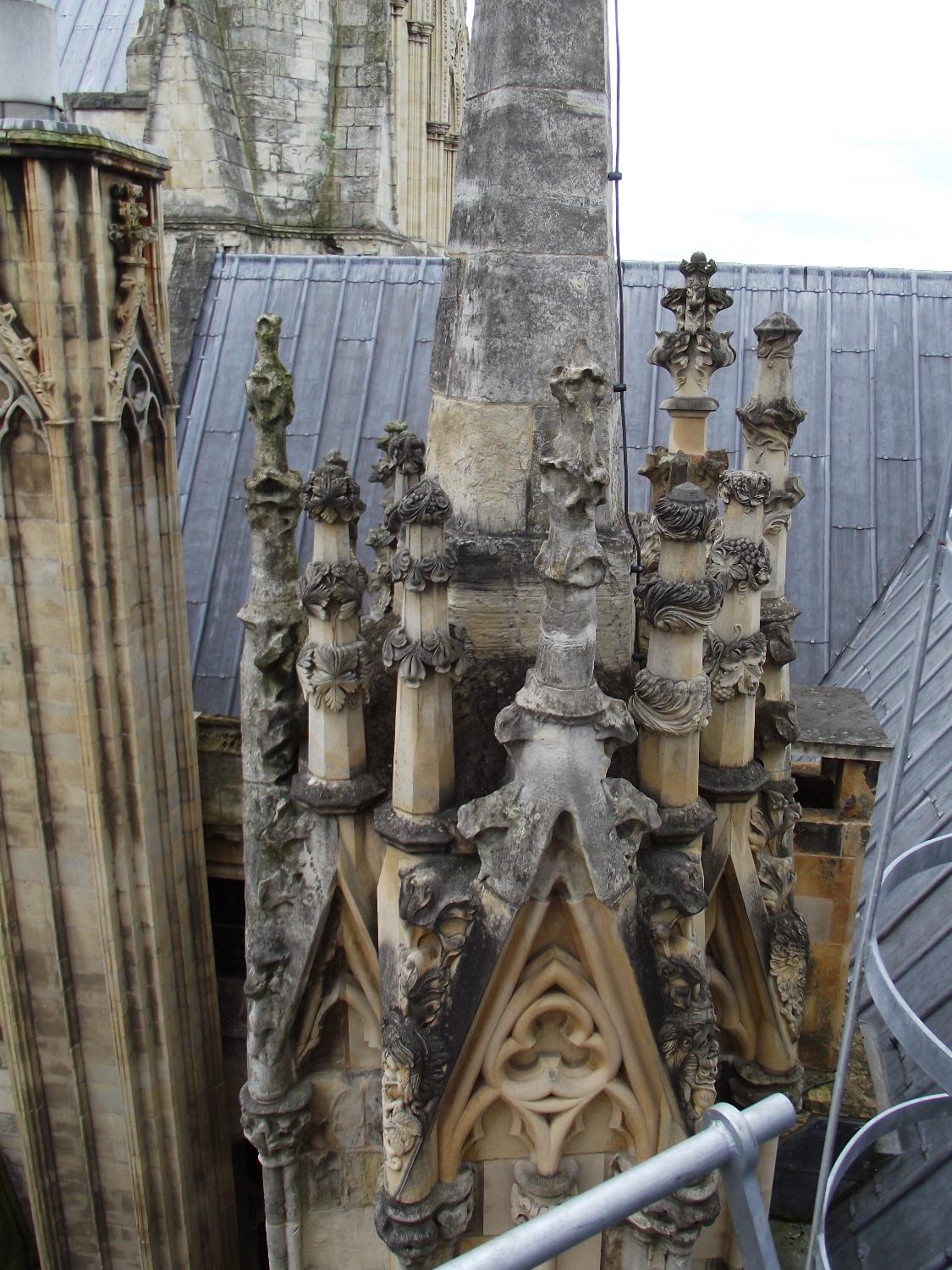 Some of York Minster's decorative roof finials show severe weathering, as well as areas where restoration has taken place.
