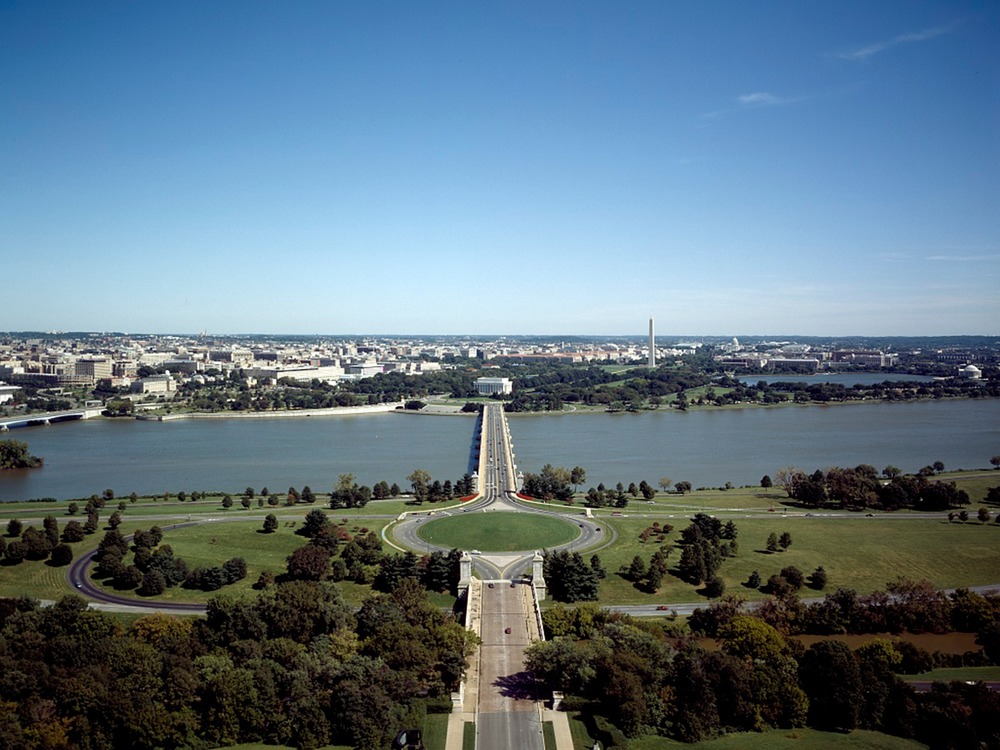 Memorial Bridge and Avenue from Arlington, Virginia is the ceremonial entrance into Washington, D.C.; the roadway leads to the Lincoln Memorial. To the right on the image is the tall Washington Monument, and at the far right is the Jefferson Memorial on the Tidal Pool. To the left one can see the Theodore Roosevelt Memorial Bridge and just the corner of the Kennedy Center. Image courtesy of the US National Park Service.