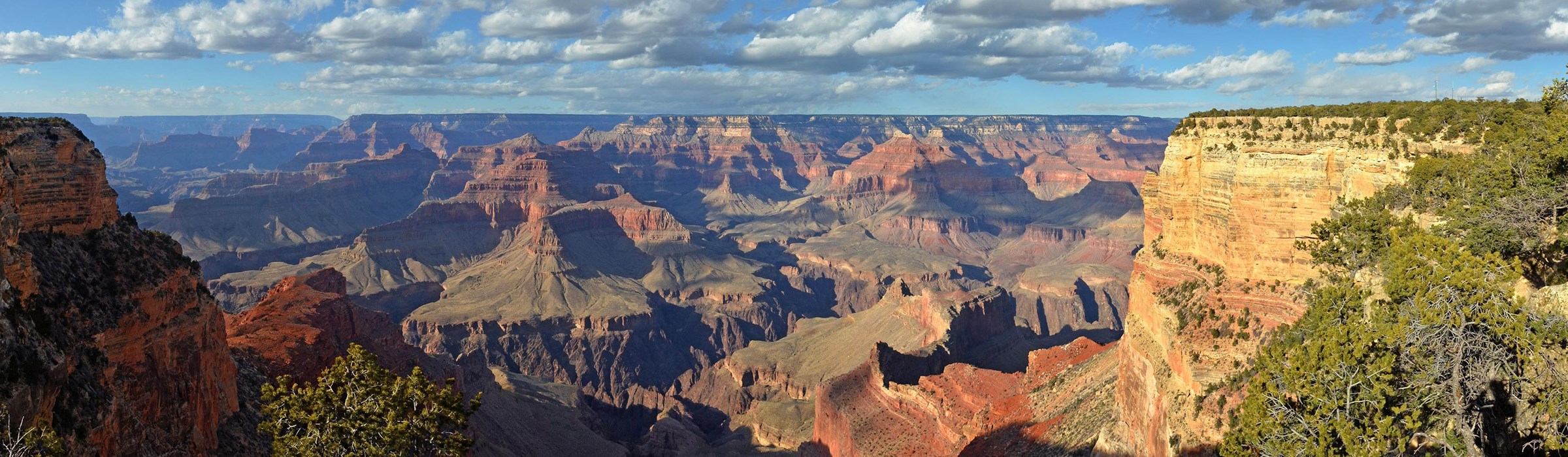 Grand Canyon panorama. The Grand Canyon began to take shape some 5 to 6 million years ago as the Colorado Plateau was uplifted. The Colorado River and its tributaries and channels cut through nearly two billion years of Earth's geological history in the Plateau, making the Grand Canyon a geologist’s mecca.  The Grand Canyon is 446 km (277 mi) long, up to 29 km (18 mi) wide, and attains a depth of over a mile (1,857 m or 6,093 ft).  Image courtesy of the National Park Service.