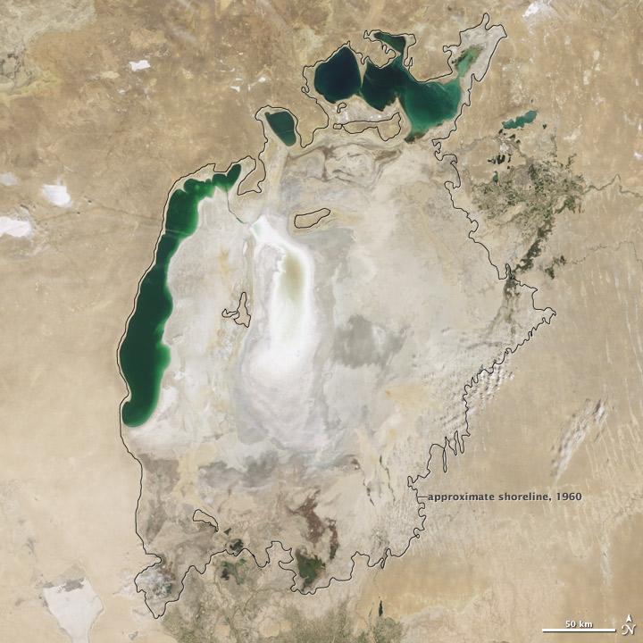 Throughout the first half of the 20th century, the Aral Sea was the world's fourth-largest lake. In the 1960s, the Soviet Union began a massive irrigation project in what are now Kazakhstan, Uzbekistan, and Turkmenistan, diverting water from the rivers that feed the Aral Sea to irrigate farmland. As its water levels dropped, the lake began splitting into smaller pieces: the Northern (Small) Aral Sea and the Southern (Large) Aral Sea. The Southern Aral Sea further split into eastern and western lobes. In August 2009 when this photo was taken, the Northern Aral Sea (upper right) still appeared healthy, the Southern Aral Sea consisted of two isolated water bodies: an irregular oval shape directly southwest of the Northern Aral Sea, and the long, thin remainder of the Southern Aral Sea's far western lobe. Much of what finally doomed the Southern Aral Sea was an attempt to save its neighbor to the north. In 2005, Kazakhstan built the Kok-Aral Dam between the lake's northern and southern portions to preserve water levels in the north. The Northern Aral Sea actually exceeded expectations with the speed of its recovery, but the dam ended prospects for a recovery of the Southern Aral Sea, which some authorities already regarded as beyond help. Lake sediments from this depleted water body have provided ample material for frequent dust storms. Image courtesy of NASA. 