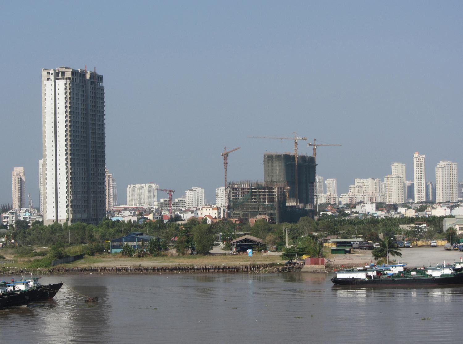 View of Ho Chi Minh City (aka Saigon) from the Saigon River. Saigon is Vietnam's major port and, with 8 million inhabitants, its largest city. It was called Saigon until 1975 when it was renamed Ho Chi Minh City following its capture by North Vietnamese communist forces. Although the city's commercial core is officially called Saigon, the entire city is widely referred to as Saigon even in the North. The city was architecturally influenced by the French during their colonial occupation of Vietnam. Numerous classical Western-style building in the city reflect this, so much so that Saigon was referred to as "The Pearl of the Far East" or "Paris in the Orient." In more recent years, a building boom has transformed the skyline of the city.