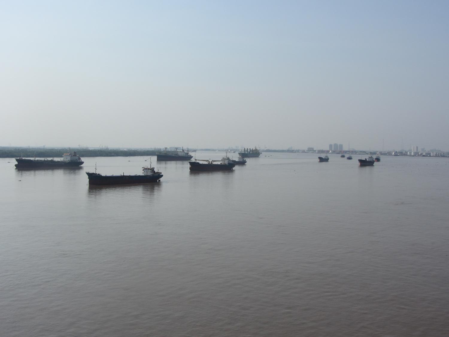 A small flotilla of boats on the  Saigon River, which serves as the main water source for the port of Saigon. 