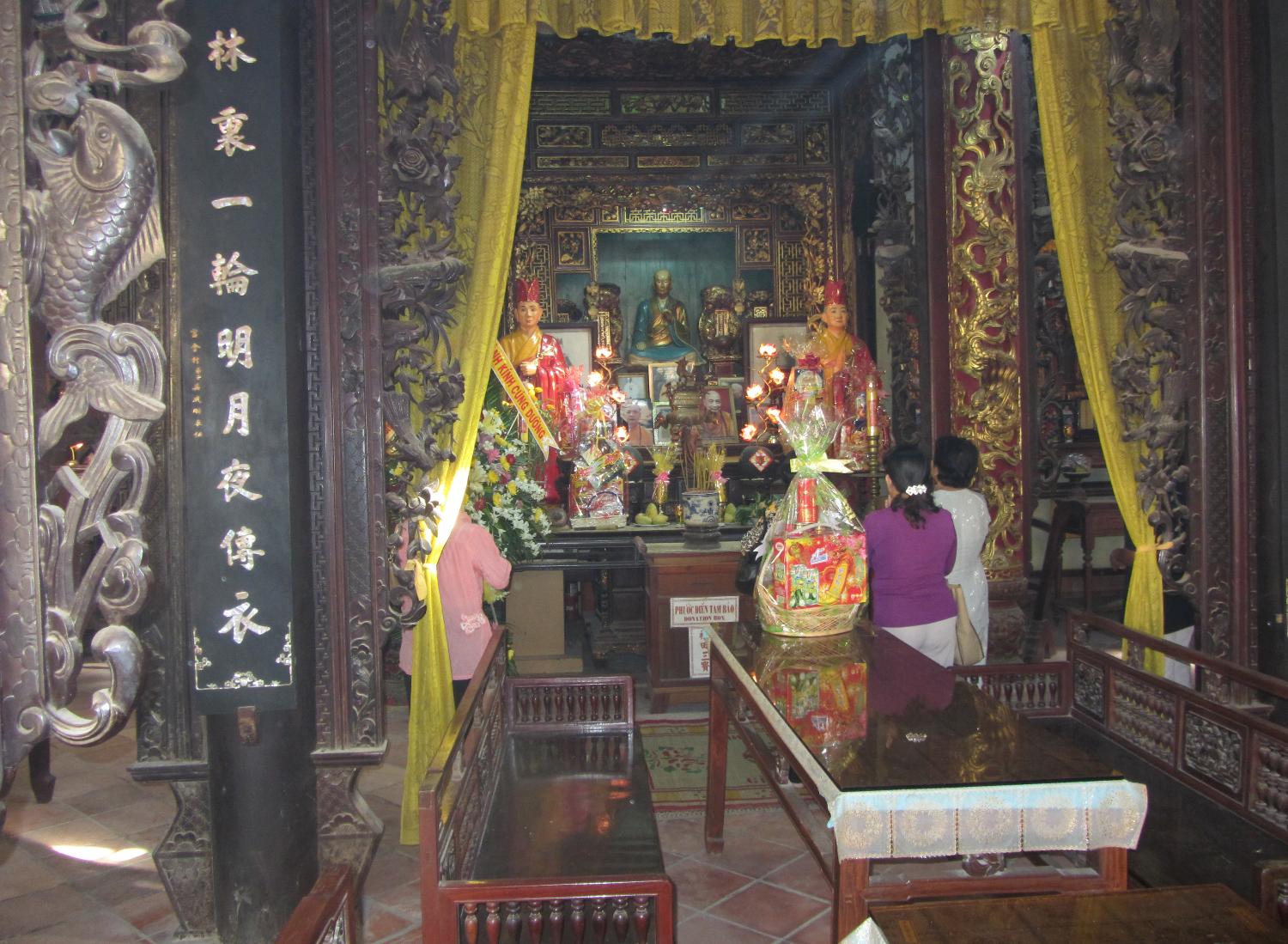 Shrine in the interior of the Vinh Trang Pagoda near the city of My Tho. Known of the "Gateway to the Mekong Delta," My Tho lies on the My Tho River, a branch of the Mekong River, 70 km (45 mi) south of Saigon (Ho Chi Minh City). First completed in 1851, the Vinh Trang temple has been reconstructed a number of times.  