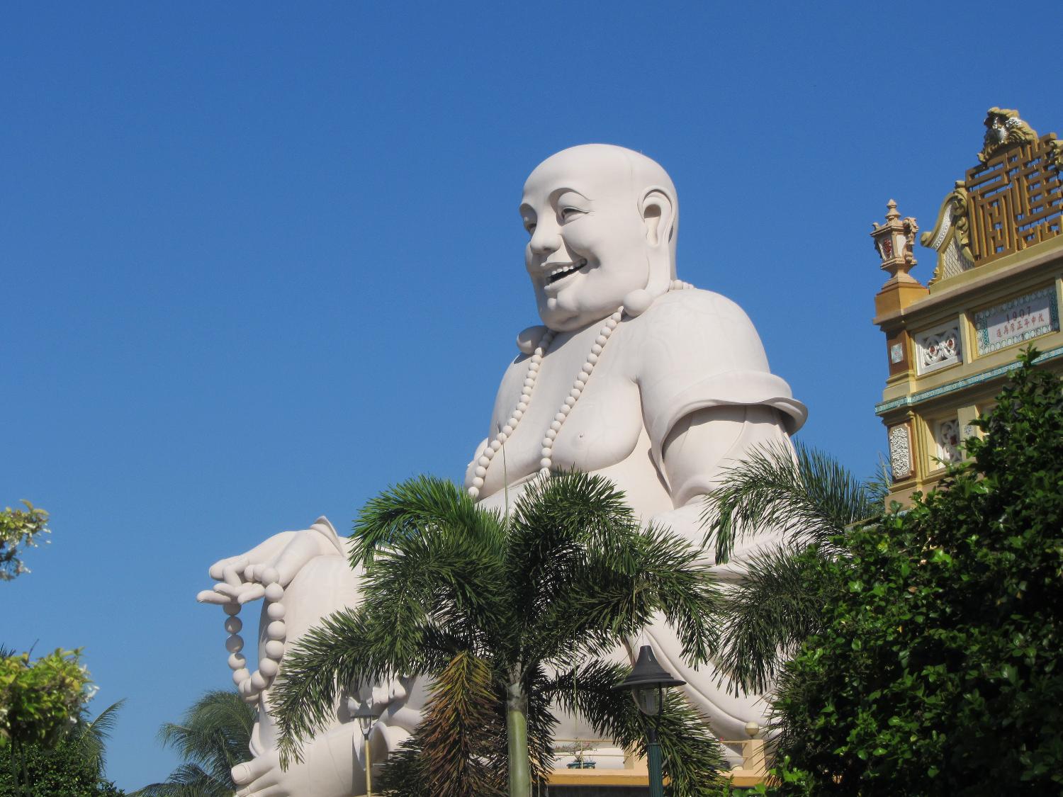Laughing Buddha at the Vinh Trang Pagoda near the city of My Tho. First completed in 1851, the Vinh Trang temple has been reconstructed a number of times. 