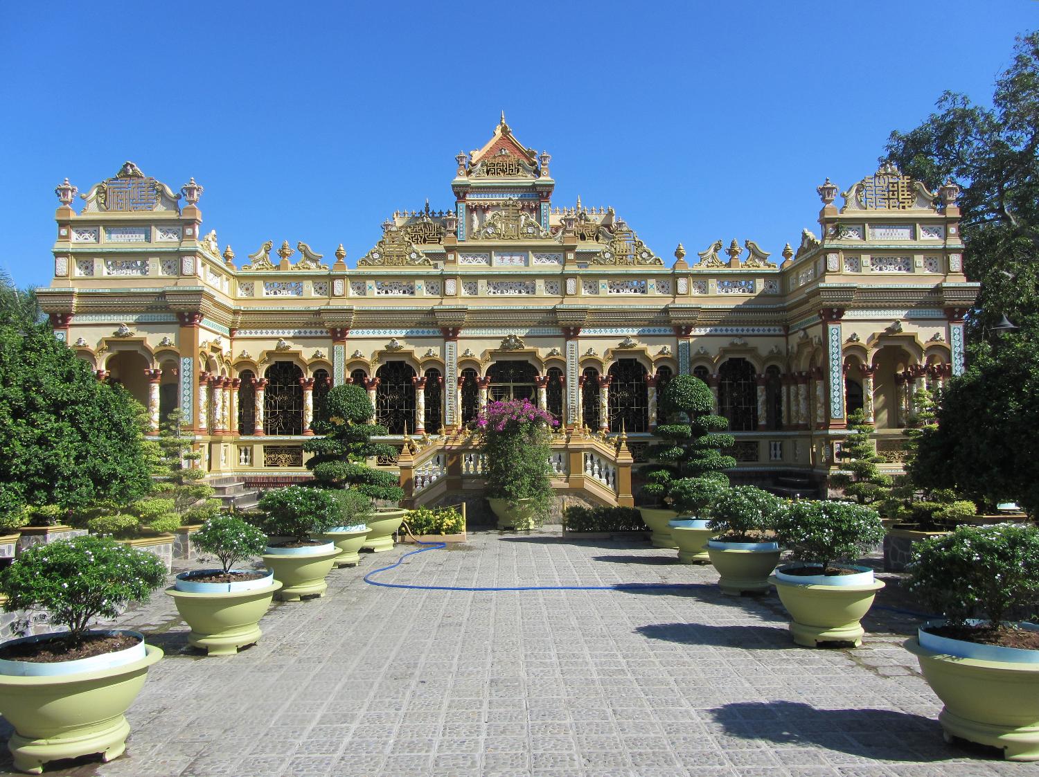 Vinh Trang Pagoda near the city of My Tho. Known of the "Gateway to the Mekong Delta," My Tho, with a population in excess of 200,000, lies on the My Tho River, a branch of the Mekong River, 70 km (45 mi) south of Saigon (Ho Chi Minh City).  First completed in 1851, the Vinh Trang temple has been reconstructed a number of times.  