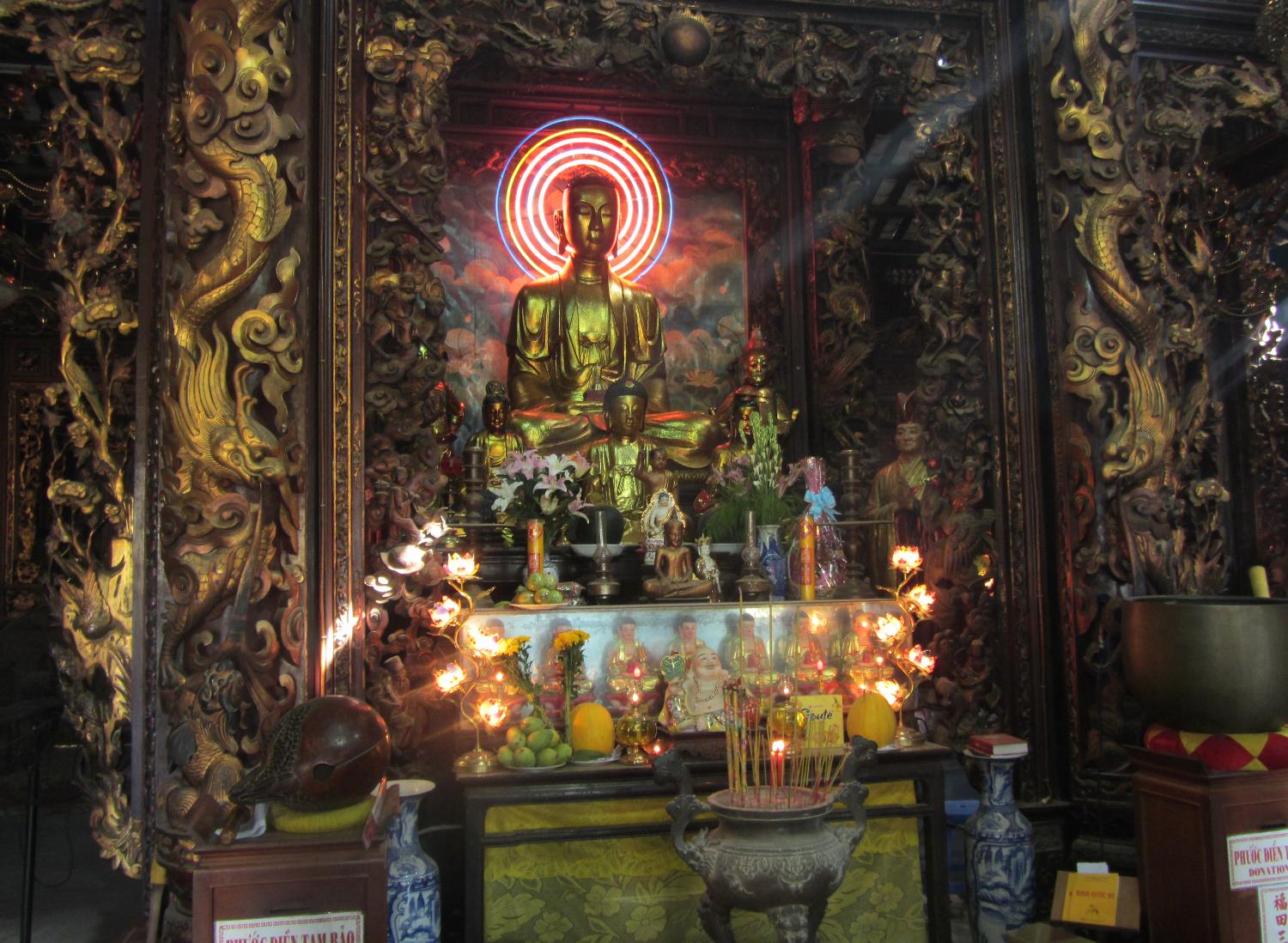 Shrine in the interior of the Vinh Trang Pagoda near the city of My Tho. Known of the "Gateway to the Mekong Delta," My Tho lies on the My Tho River, a branch of the Mekong River, 70 km (45 mi) south of Saigon (Ho Chi Minh City). First completed in 1851, the Vinh Trang temple has been reconstructed a number of times. 