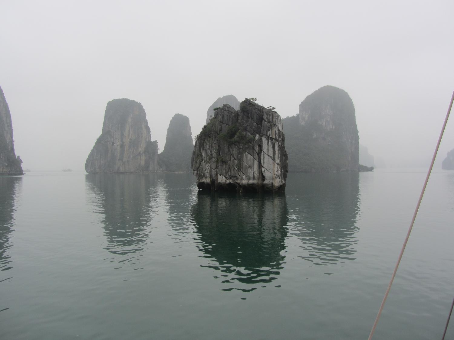 Ha Long Bay in northern Vietnam near the border with China and 170 km east of Hanoi. The bay, which is a World Heritage site,  has 1,969 monolithic limestone islands rising from the water many topped with vegetation. 