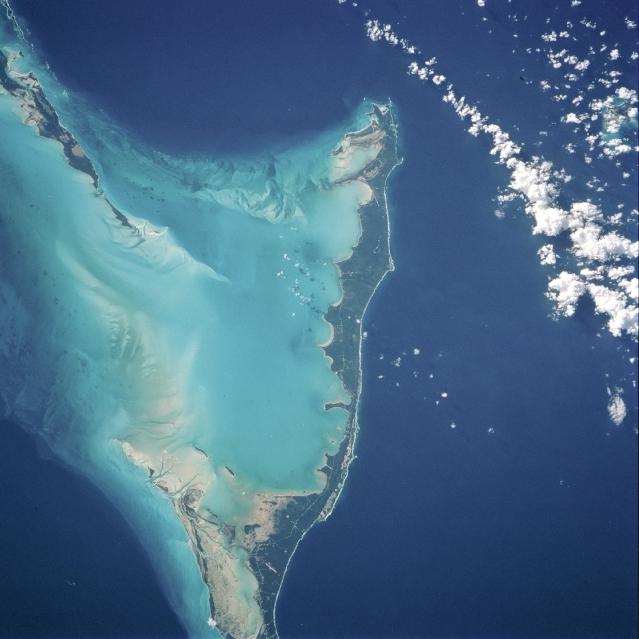 The vivid blues of the Bahamas stand out from space. The northern half of Long Island and the southern half of Great Exuma Island (extending to the northwest) are on the eastern side of the Great Bahama Bank and form the borders of Exuma Sound. Image courtesy of NASA. 