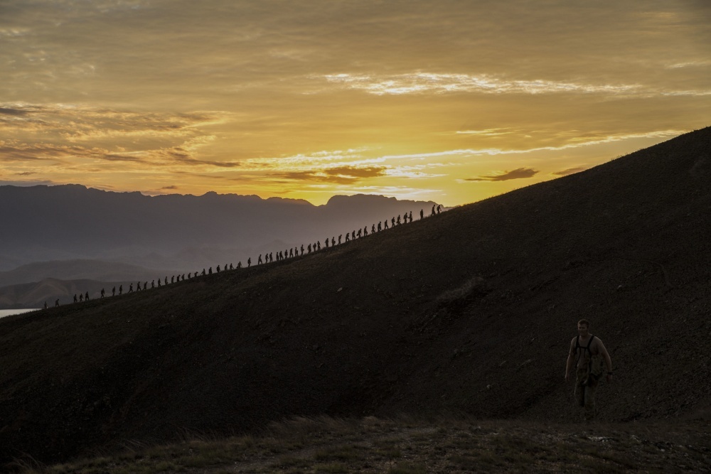 As part of a multinational training exercise, US Marines and US Sailors, Australian soldiers, and British soldiers hike a hill along the Kokoda Track in Papua New Guinea in 2015. The exercise was designed to provide assistance to Papua New Guinea through infrastructure rehabilitation and basic military training. Photo courtesy of the US Marine Corps/ Cpl. William Hester.