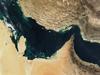 The Persian Gulf (left) and the Gulf of Oman (right) were once the site of a rift, an area where two plates of the earth's crust pulled apart from each other. The Indian Ocean filled in the widening gap between the two plates. Over time, the process reversed, and about 20 million years ago, the gulfs began to close up. The ongoing collision of the two continental plates resulted in Iran's mountainous terrain (top) and its periodic earthquakes. 

Several Gulf States are visible across the eastern Arabian Peninsula that makes up the lower part of the image. In addition to Saudi Arabia across the bottom, the islands of Bahrain in the left center lie next to the prominent peninsula that makes up Qatar. Further to the right are various offshore islands of the United Arab Emirates; most of the darker area to the right makes up Oman. Photo courtesy of NASA.


