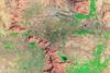 For more than 3,000 years, Kabul has occupied a strategic location along Central and Southern Asian trade routes. In the late eighteenth century, Kabul was established as Afghanistan's capital.
In this false-color satellite image vegetation appears fluorescent green, urban areas range in color from gray to black, and bare ground varies in color from beige to reddish brown. A mountain range, including Kohi Asamayi and Kohi Bini Hisar, snakes through the scene, running roughly northwest-southeast. More peaks appear in the northeast, right next to an airport. Urbanization appears densest at the city's center, just southwest of the airport, and it stretches out toward the right side of the image along an east-west highway. Leaping a mountain boundary, cityscape also fills the lower-left quadrant of the image.
Partly constrained by surrounding mountains, Kabul's primary direction for growth has been vertical, with multistory buildings constructed atop existing structures. Photo courtesy of NASA.