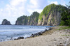 A quiet rocky beach at the end of the Tuafanua Trail on the north shore of Tutuila, looking out toward Pola Island. Photo courtesy of the US National Park Service.