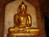 A golden Buddha statue sits in one of Bagan's many pagodas.