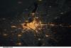 A night view of the Montreal metropolitan area is featured in this image from the International Space Station. This photo of the Montreal, Quebec  metropolitan area (center) illustrates the extent of urbanization made clearly visible by city lights at night. Major roadways and industrial areas are traced by bright white lighting, while the adjacent residential and commercial land uses are characterized by more diffuse yellow-gold lighting. Rivers and other water bodies appear black, while the surrounding rural countryside is faintly illuminated by moonlight. Blurry areas at top and bottom left are caused by cloud cover. Montreal is the largest city in the dominantly French-speaking province of Quebec, and the second-largest in Canada, after Toronto. While the city of Montreal proper is located on - and almost completely covers - the Island of Montreal at the confluence of the St. Lawrence (center) and Ottawa Rivers (not visible), the city takes its name from Mont Royal located at the city's center. Image courtesy of NASA.


