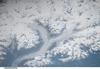 The snow-covered Coastal Mountains of British Columbia are featured in this image taken from the International Space Station. The long smooth areas are glaciers. Photo courtesy of NASA.
