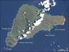 Discovered by Dutch sailors on Easter Sunday 1722 and named for the holy day, the isolated Pacific island had already been inhabited for more than one thousand years, most likely settled by Polynesian sailors in canoes between A.D. 400 and 700. The most amazing cultural artifacts on display were giant stone statues, called moai, resting on ahu, raised platforms of expertly fitted stones. Most of the hundreds of moai on the island were carved out of volcanic rock in the crater of Rano Raraku, located in the southeastern part of the island. In addition to the many moai scattered around the coast of the island, Rano Raraku is littered with moai, some only half-carved, others that appear to have broken in the attempt to remove them from the quarry, and still others that seem to simply have been abandoned. East of Rano Raraku is Ahu Tongariki, where in 1960 a tidal wave caused by an earthquake in Chile struck the southern coastline and swept 15 moai inland for several hundred feet. In 1992, the site was restored by a Chilean archeologist. On the western end of the island is the only town, Hanga Roa, where most of Rapa Nui's 2,000 residents live. South of the town is the island's largest volcanic crater, Rana Kao. Along the crater rim looking southward over the coast, lie the ruins of Orongo, a ceremonial site containing elaborate stone carvings and other artwork. Landsat image courtesy of NASA.