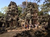 Ta Prohm is the modern name of the temple in Siem Reap, built largely in the late 12th and early 13th centuries. Located approximately 1 km east of Angkor Thom, it was founded by the Khmer King Jayavarman VII as a Buddhist monastery and university. Unlike most Angkorian temples, Ta Prohm remains in much the same condition as when it was found. The photogenic and atmospheric combination of trees growing out of the ruins and the jungle surroundings have made it one of Angkor's most popular temples with visitors. UNESCO inscribed Ta Prohm on its World Heritage List in 1992. Today, it is one of the most visited complexes in Cambodia’s Angkor region.