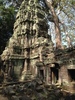 Ta Prohm is the modern name of the temple in Siem Reap, built largely in the late 12th and early 13th centuries. Located approximately 1 km east of Angkor Thom, it was founded by the Khmer King Jayavarman VII as a Buddhist monastery and university. Unlike most Angkorian temples, Ta Prohm remains in much the same condition as when it was found. The photogenic and atmospheric combination of trees growing out of the ruins and the jungle surroundings have made it one of Angkor's most popular temples with visitors. UNESCO inscribed Ta Prohm on its World Heritage List in 1992. Today, it is one of the most visited complexes in Cambodia’s Angkor region.