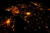 Several of the oldest cities of northwestern Europe are highlighted in this astronaut photo of 10 August 2011. While the landscape is dotted with clusters of lights from individual urban areas, the metropolitan areas of London (lower left), Paris (center), Brussels, and Amsterdam (upper left) stand out due to their large light "footprints." The metropolitan area of Milan is also visible at image upper right. While each of these cities is, or has been, the capital of a kingdom, republic, or empire - Paris and London have been all three - Brussels is also the capital city of the European Union. To give a sense of scale, the centers of the London and Paris metropolitan areas are approximately 340 km (210 mi) from each other. The image is also oblique making the distance between Paris and Milan (640 km, or 400 mi) appear less than that of Paris to London. In contrast to the land surface defined by the city lights, the English Channel presents a uniform dark appearance. Similarly, the Alps near Milan are also largely devoid of lights. While much of the atmosphere was clear at the time the image was taken, the lights of Brussels are dimmed by thin cloud cover. Image courtesy of NASA.

