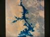 The Aswan High Dam (top of photo) is 4 km (2.5 mi) across and 111 m (364 ft) high. Completed in 1971, it was constructed to supply cheap hydroelectric power to both Egypt and Sudan by impounding, controlling, and regulating the flood waters of the Nile River in Lake Nasser, the world's second largest artificial lake. The lake extends over 800 km (500 mi) in length, covers an area of some 5,200 sq km (2,000 sq mi) and is as much as 107 m (350 ft) deep at the face of the dam. Click on photo for higher resolution. Image courtesy of NASA. 
