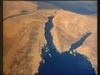 A panoramic view of the entire Sinai Peninsula and the nearby Nile River Delta and eastern Mediterranean coastal region. The Suez Canal, at the top of the scene just to the right of the Delta, connects the Mediterranean Sea with the Gulf of Suez. The water body to the right of the peninsula is the Gulf of Aqaba. Click on photo for higher resolution. Image courtesy of NASA. 
