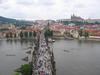 The bustling, pedestrian-friendly Charles Bridge as viewed from the tower on the Stare Mesto (Old Town) side of the structure. The bridge is 516 m long and almost 10 m wide and rests on 16 arches shielded by ice guards. Thirty statues of saints decorate the bridge avenue; most were originally erected between 1683 and 1714, but then replaced with replicas beginning in 1965. The originals are currently housed in the National Museum. 