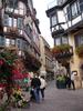 Half timbered houses along a shopping street in old Colmar. 