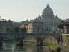 The Vittorio Emanuele Bridge over the Tiber River in Rome with Vatican City (and St. Peter's Basilica) in the background. 