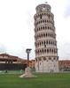 The famous Leaning Tower at Pisa. A statue of the legendary founders of Rome, Romulus and Remus, being suckled by a she-wolf appears in the foreground. 