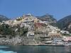 View of homes in Positano on the rugged Amalfi Coast. The city is about 18 km east of the city of Amalfi. It was a prosperous port of the Amalfi Republic during the 16th and 17th centuries. Most of the population emigrated in the 19th century, mainly to Australia. In the 1950s, the town began to become popular with artists and writers. Tourists began to arrive in the mid 1950s in large numbers. The city and area are famous for the liqueur Limoncello.
