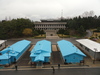 The Joint Security Area (JSA, often referred to as the Truce Village or Panmunjom) is the only portion of the Korean Demilitarized Zone (DMZ) where North and South Korean forces stood face-to-face. In 2018, North and South Korean officials agreed to clear the JSA of all landmines, weapons, and guard posts. This withdrawal was completed on 25 October 2018 and the JSA now contains just 35 unarmed security guards. The area is slated to mainly become a tourist attraction.

The photo shows South Korean soldiers standing guard at the JSA between the blue UN buildings. The white buildings are North Korean. This view is from the House of Freedom in South Korea looking towards the three-story Panmungak Hall in North Korea. 
