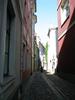 Morning sunlight illuminates a clean swept alley way in Riga. 