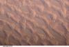 Photo shows classic large and small sand masses of the central Sahara Desert, where wind is a more powerful land-shaping agent than water. "Draa" dunes (from the Arabic for "arm") are very large masses of sand, and they appear here as the broad network of yellow-orange sand masses, with smooth-floored, almost sand-free basins between them. These sand masses lie in the western part of Libya's vast Marzuq Sand Sea. Geologists think that the draa of the Marzuq were probably formed by winds different from the prevailing north-northeast winds of today. Numerous smaller dunes have developed on the backs of the draa. Three distinct dune types are visible: longitudinal dunes, which are more or less parallel with the north winds; transverse dunes, which are usually more curved and formed at right angles to the wind; and star dunes, in which several linear arms converge towards a single peak. Image courtesy of NASA.
