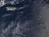 A view of Puerto Rico (upper left) and the isles of the Lesser Antilles. The Soufriere Hills Volcano on the island of Montserrat began emitting steam and ash on 9 February 2006. Low-level activity continued for several days. The volcano produced another plume on 20 March 2006, which is captured on this image. The volcano's pale beige ash plume blows westward over the Caribbean Sea. The red outline shows where the satellite detected a thermal anomaly, an area where the ground surface was significantly hotter than its surroundings. Image courtesy of NASA. 
