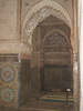 The Saadian Tombs are a historic royal necropolis in Marrakech that date to the time of the Saadian Dynasty (1549-1659). They are located on the south side of the Kasbah Mosque, inside the royal kasbah (citadel) district of the city. Because of the beauty of their decoration, the tombs have become a major attraction for visitors to Marrakech. This view offers a glimpse into the Chamber of the Three Niches from the main mausoleum. 