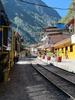 A train passing through the center of Aguas Calientes. 